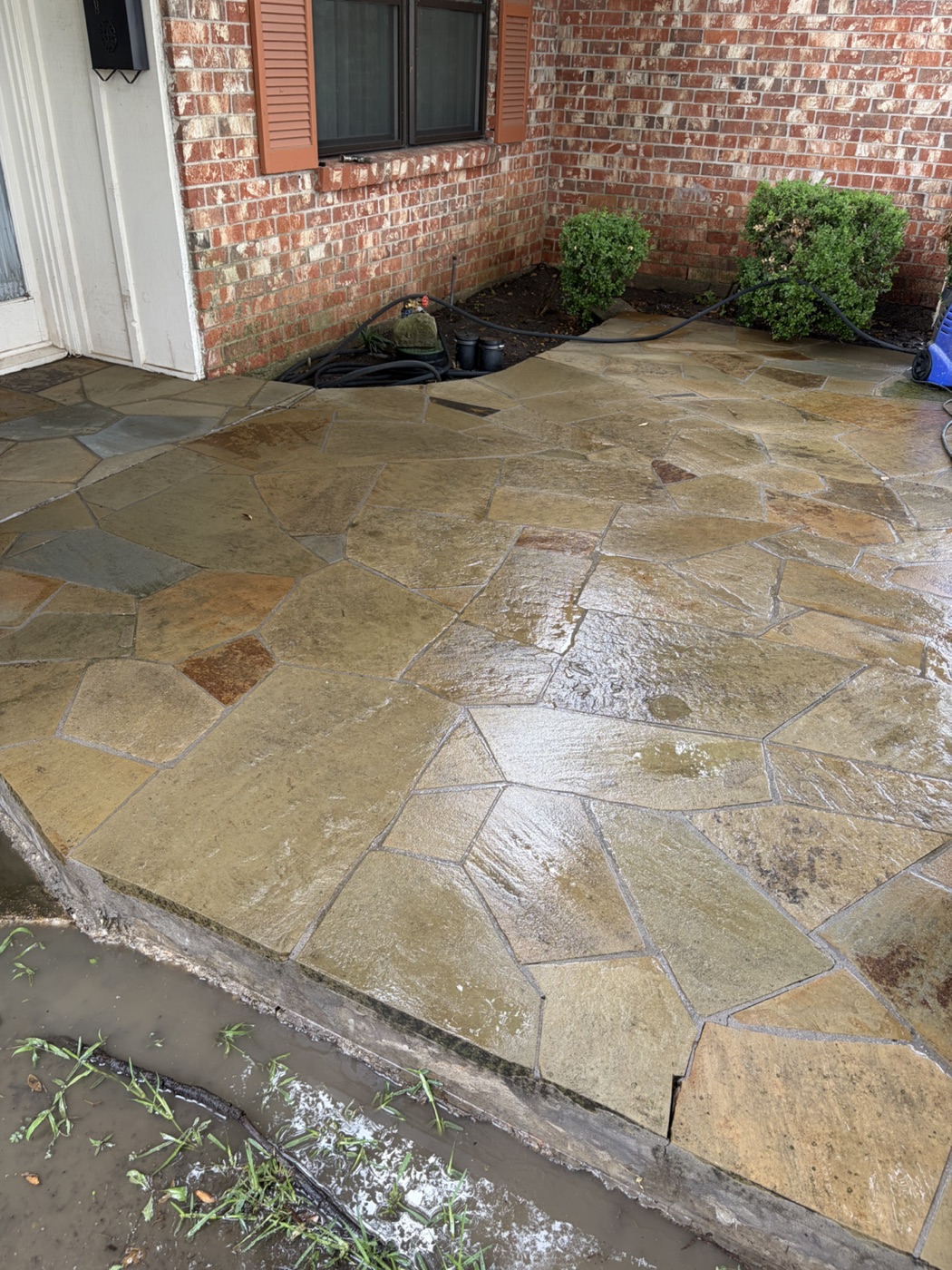 Clean wet flagstone patio after power washing