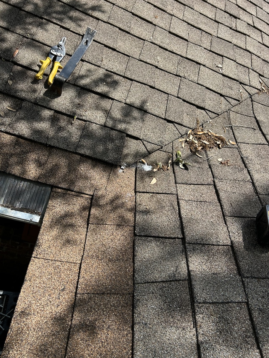 Roof repair area with shingles and roof tools